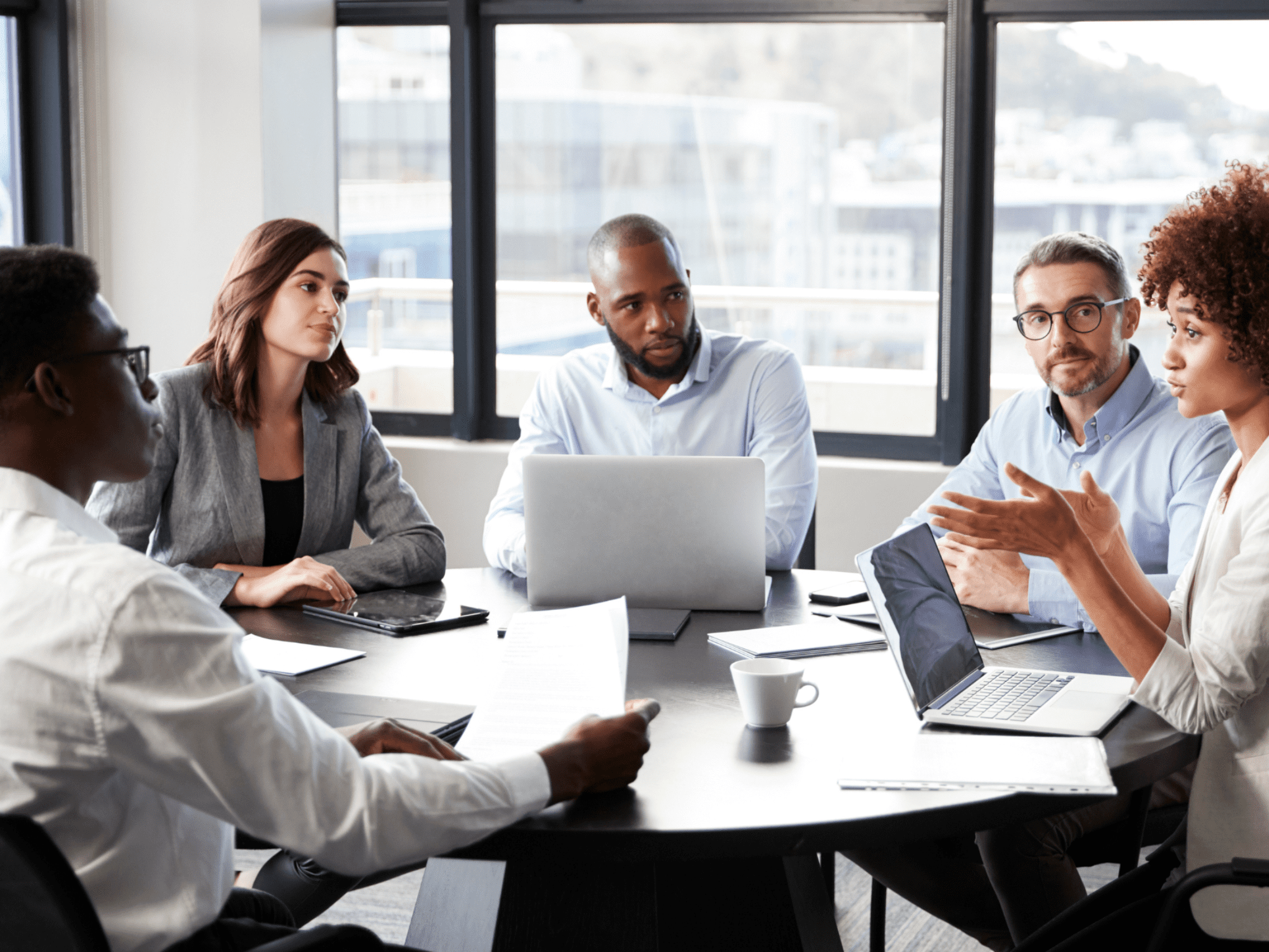 Group of people having a meeting around a conference table
