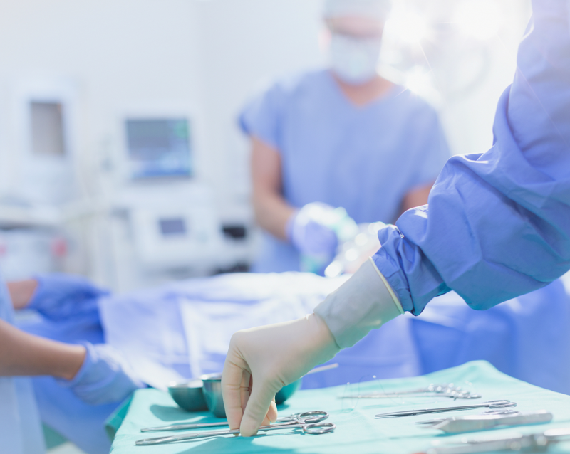 Close up on a hands touching medical tools in an operating room