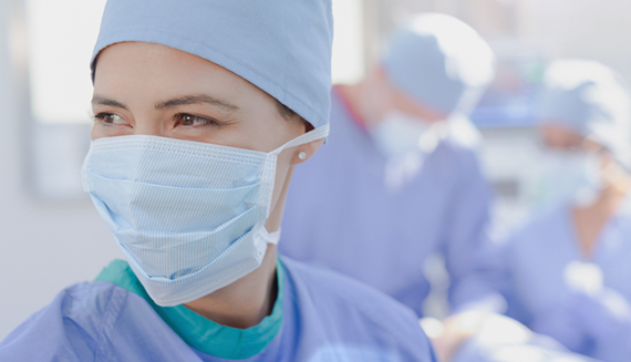 Woman in a medical mask working in an OR