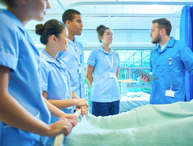 Four trainees listening to an instructor during an educational session