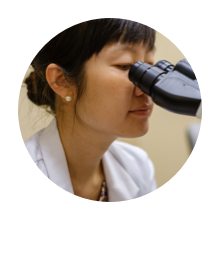 Dermatologist looking thru a microscope