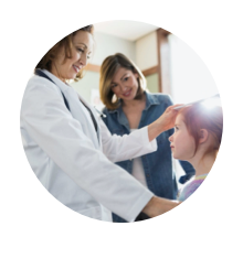 Primary care physician examining a young patient while their parent observes