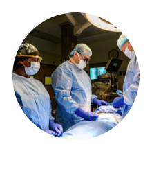 Team of three surgeons working on a patient in an operating theater