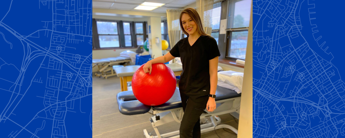 Jennifer, Senior Physical Therapist, posing with an exercise ball in the PT studio
