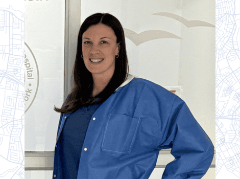 Headshot of Debra, wearing scrubs and smiling