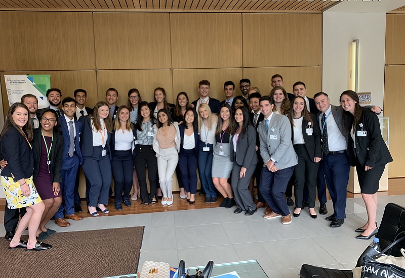 A diverse group of people in business attire standing together and smiling
