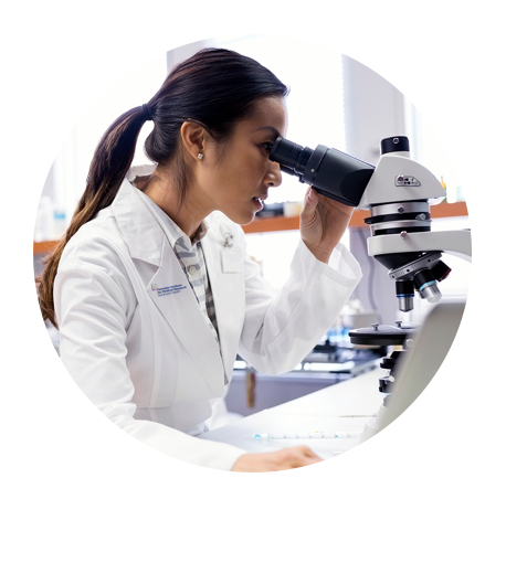 A researcher seeing through a microscope