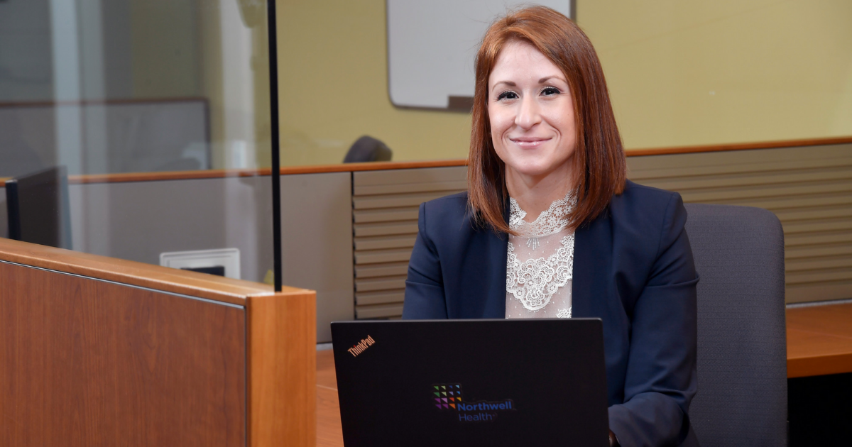 Woman in blue blazer sitting at desk