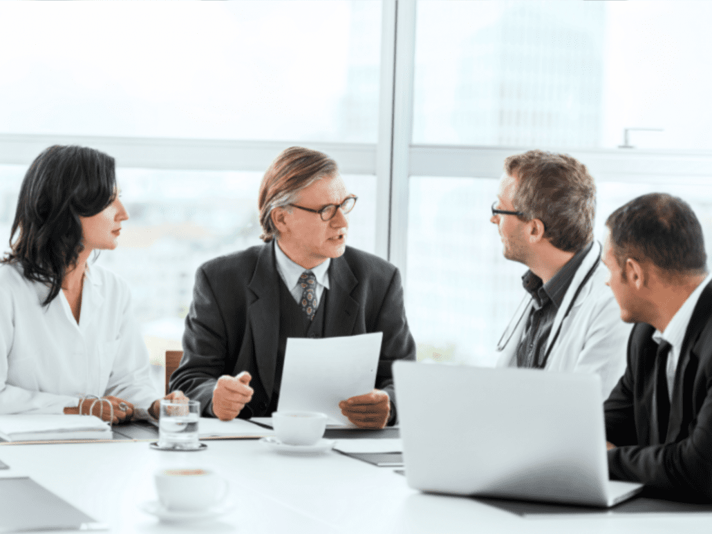 Employees at a conference table.