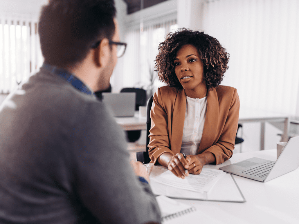 Business woman and man at desk having a discussion